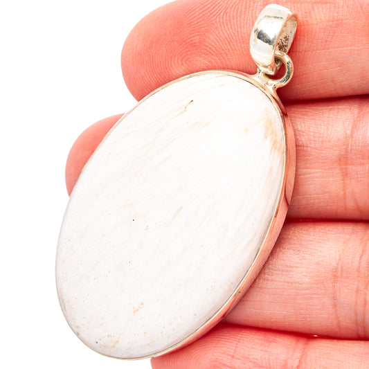 Oval white sc?lecite pendant with .925 sterling silver bail and bezel edge
