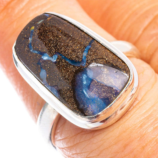 Sterling silver boulder opal ring with oval black stone and blue highlights