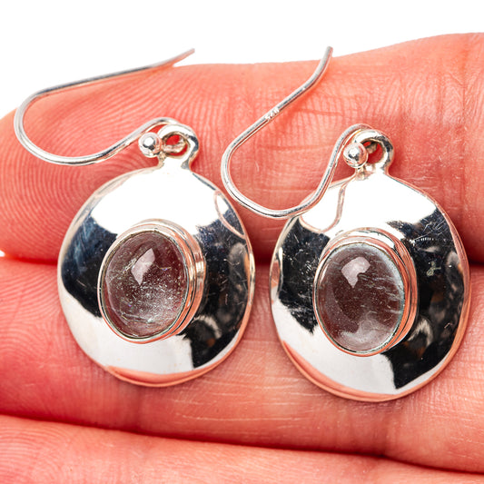 Silver hoop earrings with oval light-blue gemstone in polished round bezel