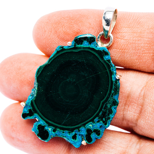 Sterling silver pendant with circular teal-green chrysocolla in malachite slice