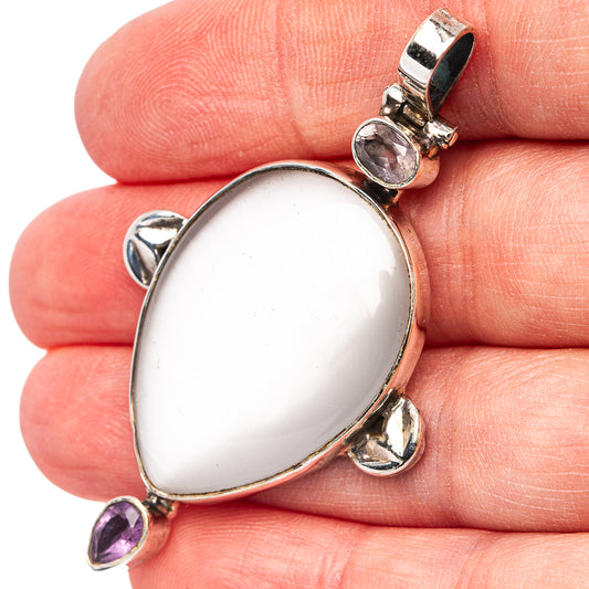 Oval white cat's-eye pendant in .925 sterling silver with small amethyst accents