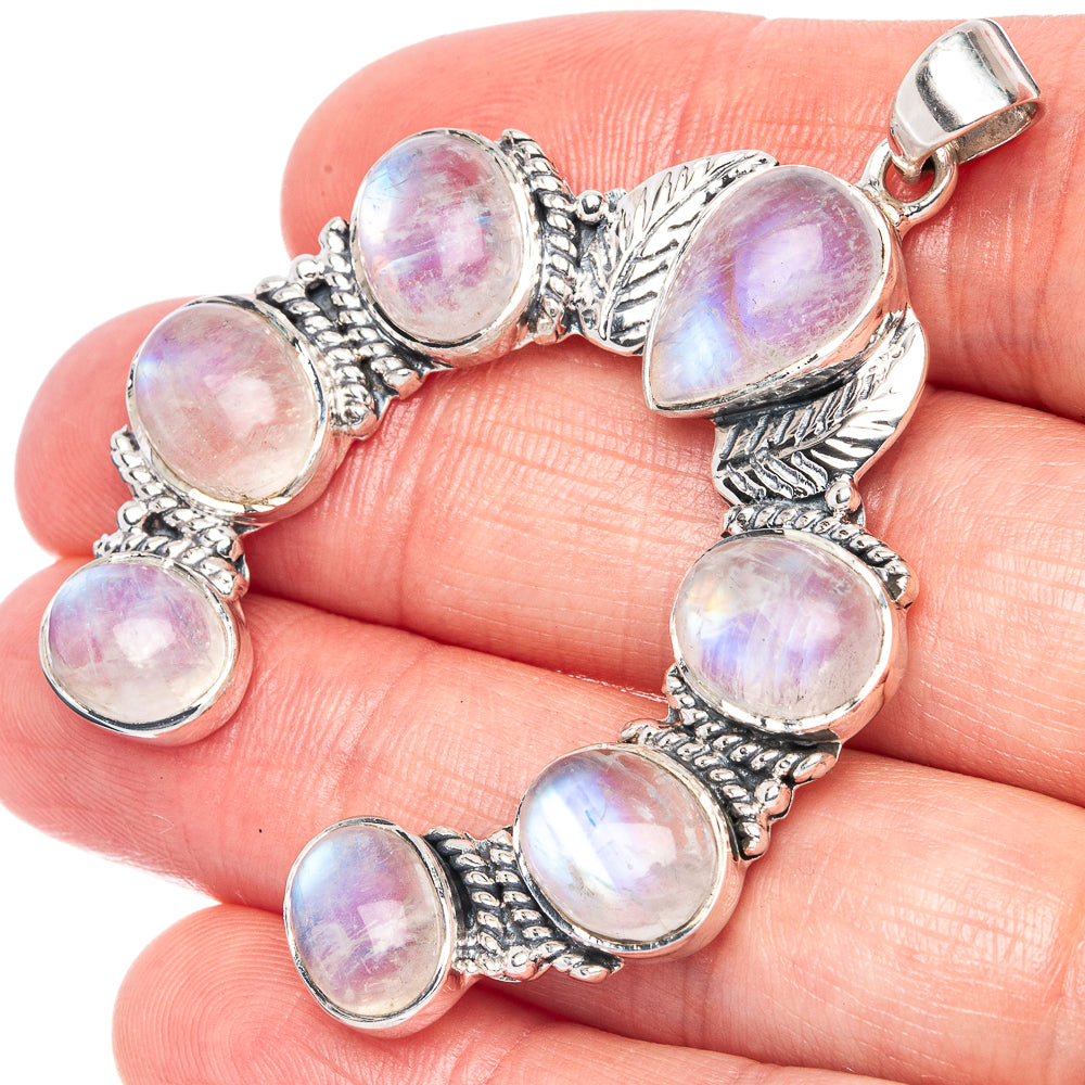Sterling silver horseshoe pendant with oval moonstone cabochons and leafy frame
