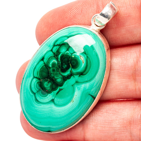 Malachite pendant in .925 sterling silver bezel, oval green stone with swirling patterns