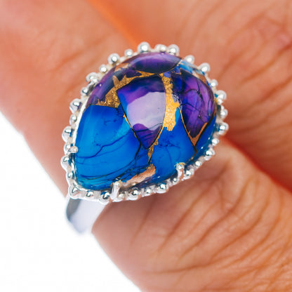 Sterling silver ring with oval blue-purple stone and bead halo, gold-toned inlay