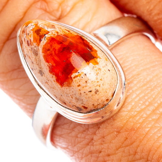 Sterling silver oval fire opal ring with orange-red gemstone cabochon, bezel setting.