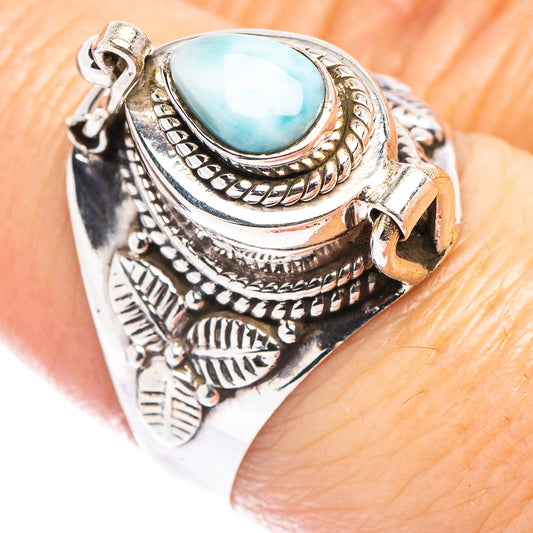 Sterling silver larimar poison ring with ornate bezel and oval light-blue gemstone