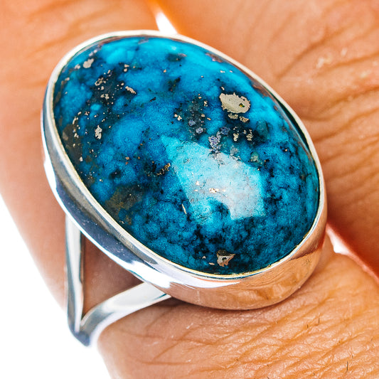 Oval turquoise cabochon sterling silver ring with raised bezel and speckled stone