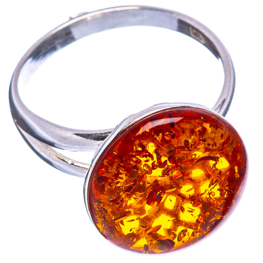 Round amber cabochon ring with open silver band and warm honey-orange center stone