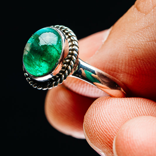 Zambian emerald sterling silver ring with oval green stone and rope-style band detail