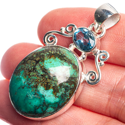 Sterling silver pendant with oval turquoise cabochon and round blue gemstone, scroll design