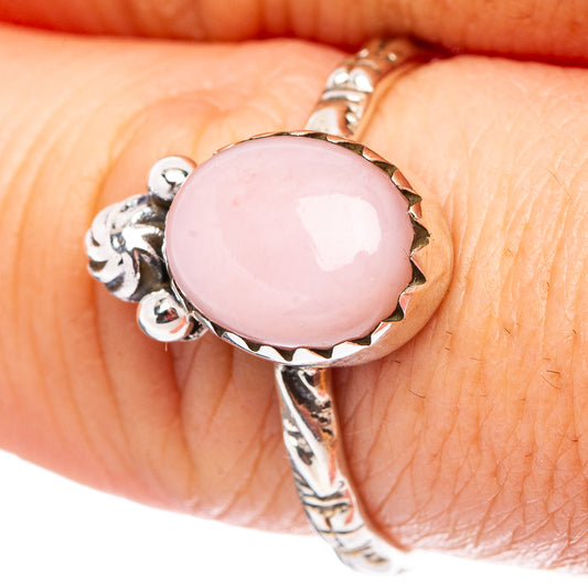 Pink opal oval sterling silver ring with ornate side details, close-up on gemstone