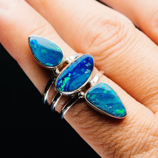 Opal doublet ring with three blue oval stones in a silver setting