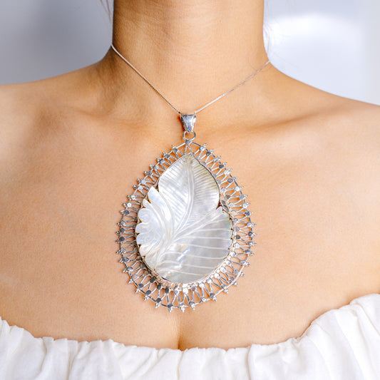Sterling silver mother-of-pearl teardrop pendant with ornate halo, on chain
