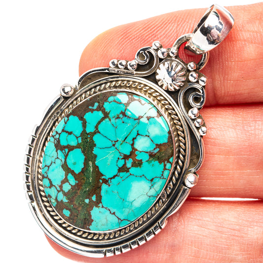 Turquoise oval pendant in .925 sterling silver bezel with ornate frame