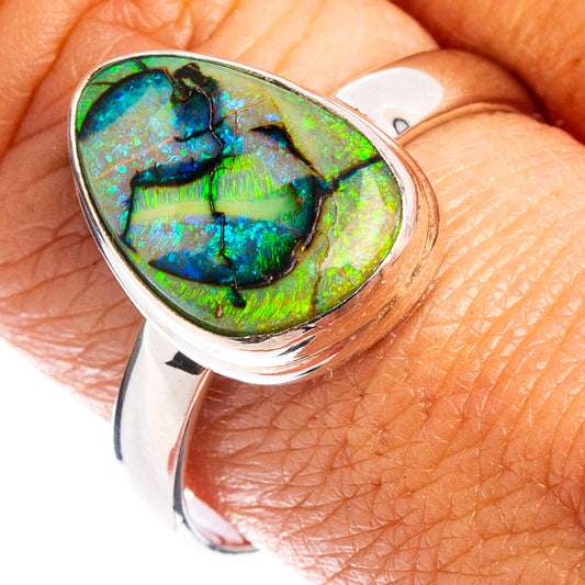 Sterling silver opal ring with green-blue teardrop cabochon, close-up view