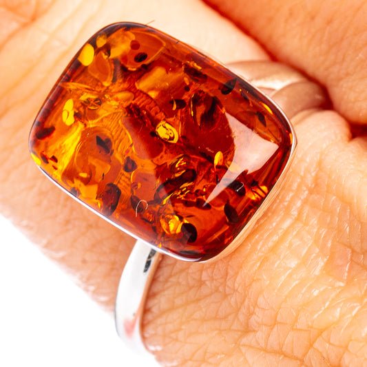 Amber cabochon ring stone in dark honey orange with polished silver bezel