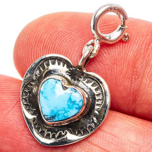 Sterling silver heart pendant with turquoise stone and ornate sunburst frame