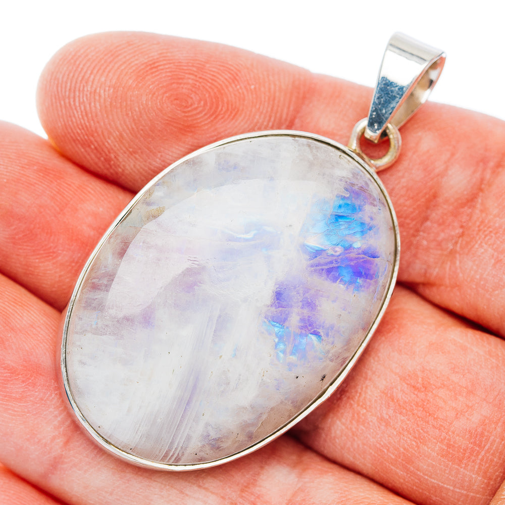 Oval sterling silver moonstone pendant with iridescent rainbow-blue flashes, hinged bail