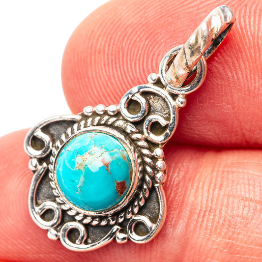 Sterling silver turquoise pendant with ornate oval setting and hinged bail