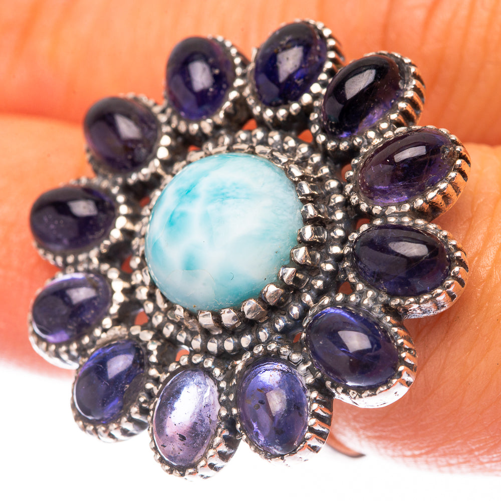 Sterling silver ring with oval light-blue larimar center and purple oval bezel stones