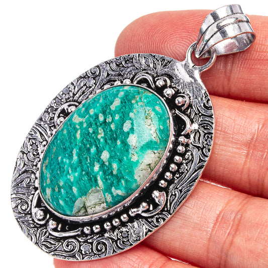 Amazonite stone pendant with ornate silver-tone oval bezel and green speckled stone.