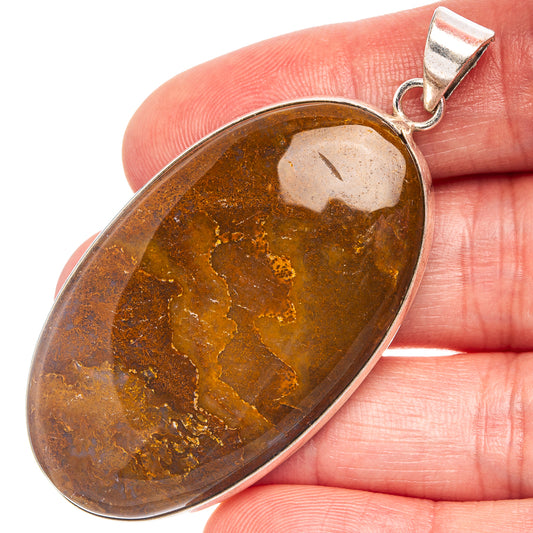Silver-plated agate pendant with oval brown stone and metal loop bail