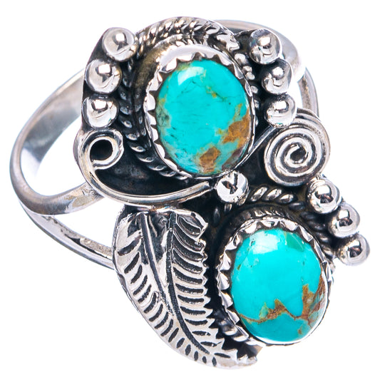 Silver turquoise ring with oval bezel stones, leaf engravings, and bead-like accents