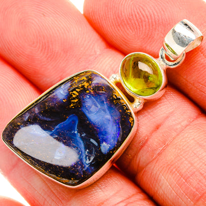 Sterling silver pendant with blue and gold boulder opal and two green peridot stones
