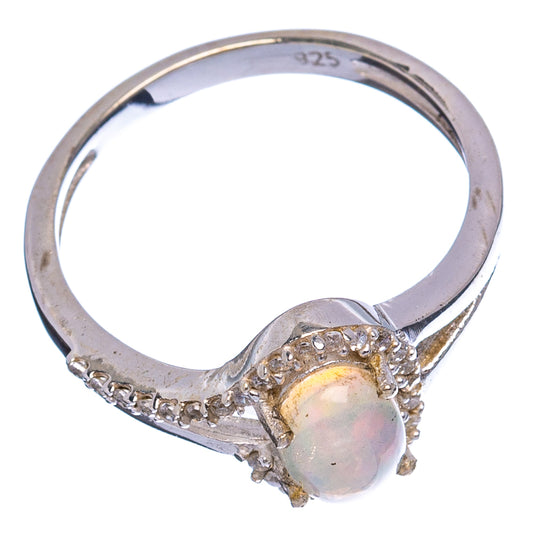 Sterling silver ring with raised opal center and cubic zirconia band, side view