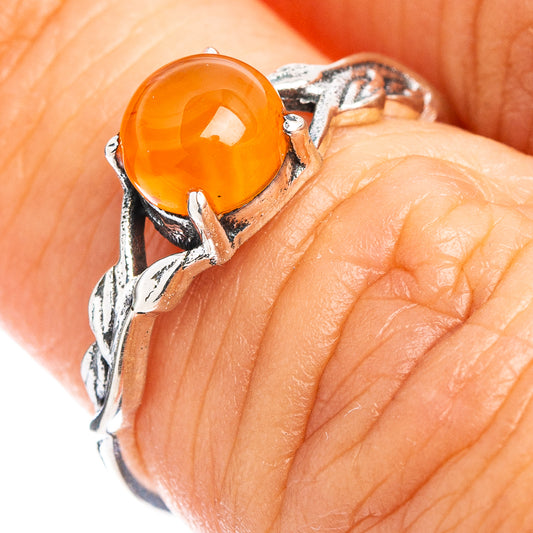 Dainty carnelian ring with oval orange gemstone in .925 sterling silver setting