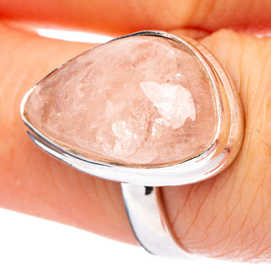 Oval rose quartz gemstone ring with polished sterling silver band, close-up