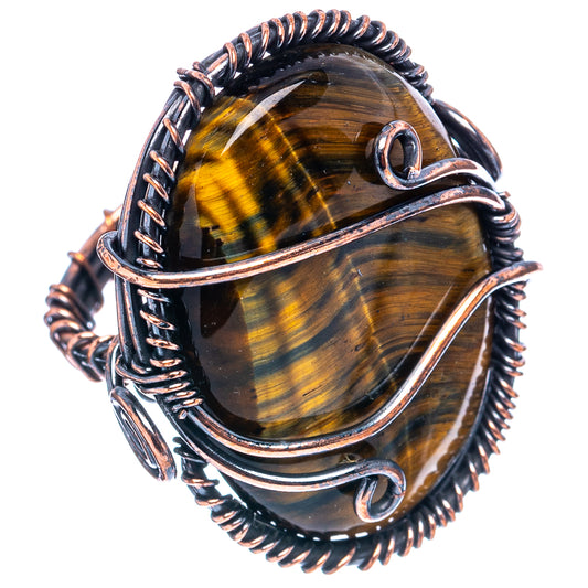 Oxidized copper wire wrap ring, oval tiger's eye stone with coiled bezel and loops.