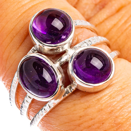 Sterling silver amethyst ring with three round purple gemstone settings