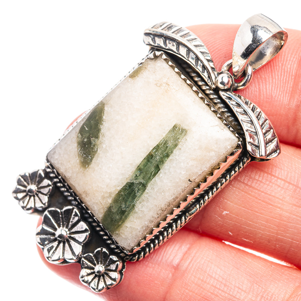 Green tourmaline in quartz pendant, rectangular stone with silver floral frame