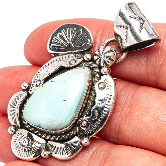 Turquoise teardrop pendant in .925 sterling silver with engraved concho-style details
