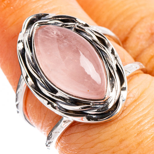 Oval rose quartz cabochon ring in polished sterling silver, twisted halo setting