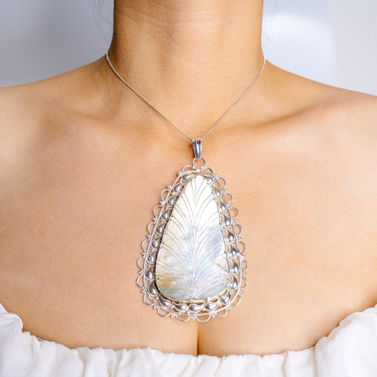 Large teardrop mother-of-pearl pendant with ornate .925 sterling silver filigree bezel