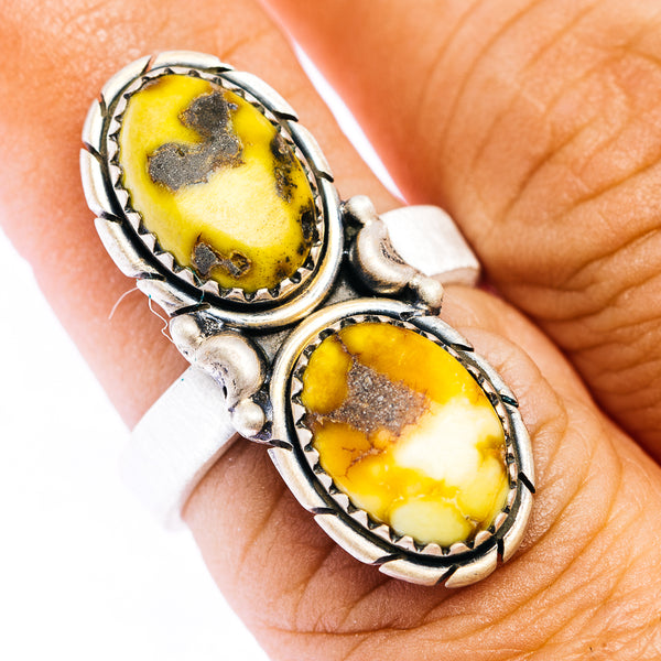 Adjustable sterling silver ring with two oval yellow stones in southwestern setting