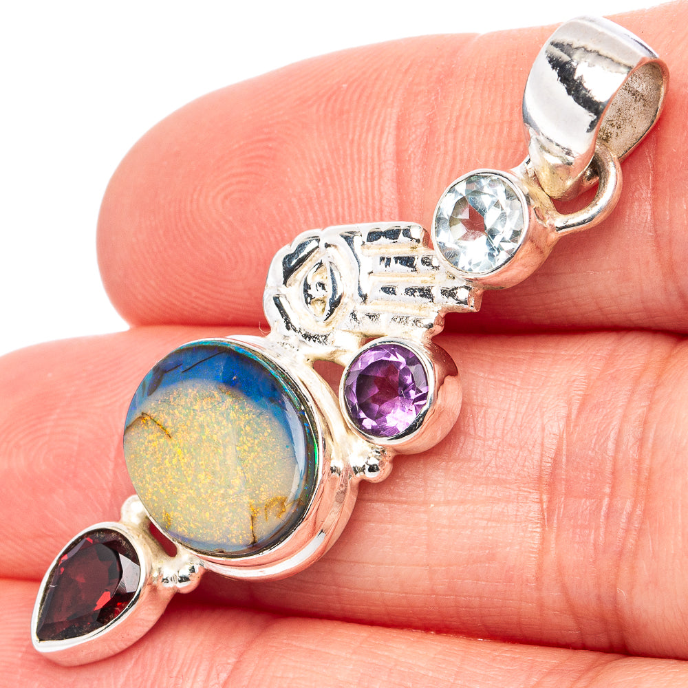 Sterling silver pendant with opal-style stone, blue topaz, purple amethyst, dark red gem