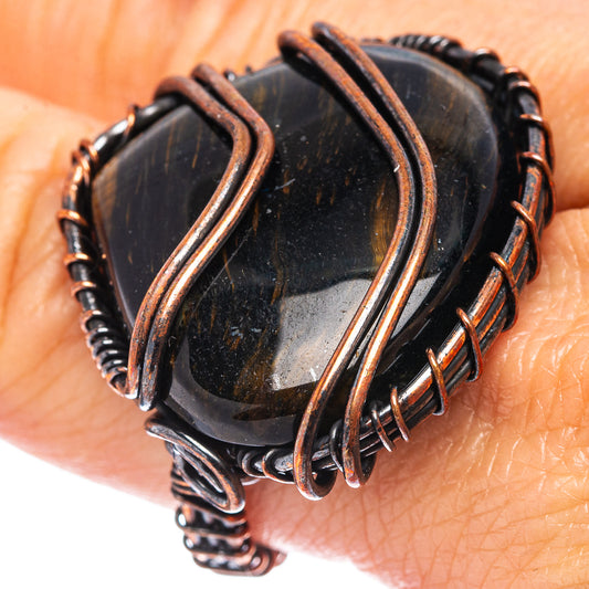 Oxidized copper wire wrap ring with dark blue tiger's eye stone and coiled accents