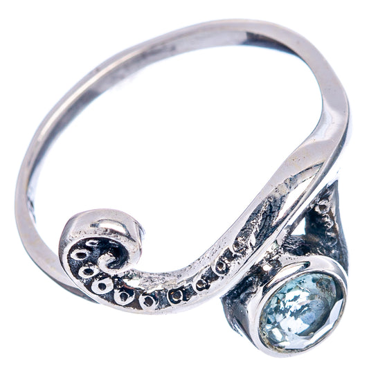 Sterling silver open wave ring with blue oval gemstone and decorative side cutouts