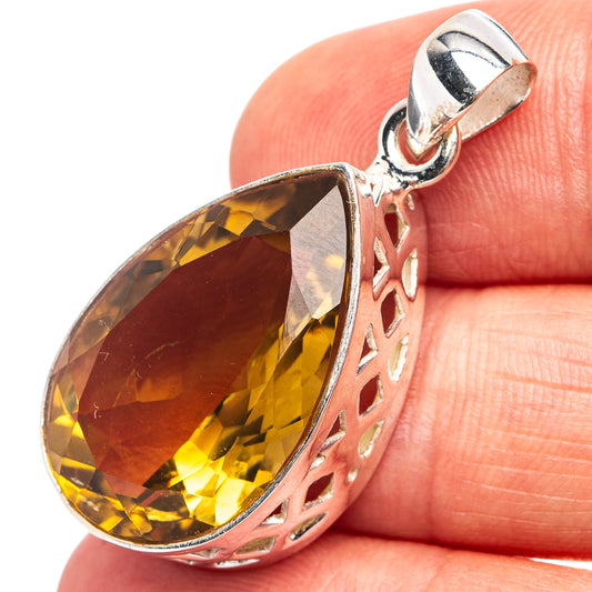 Sterling silver citrine teardrop pendant, faceted gemstone with cutout openwork setting.