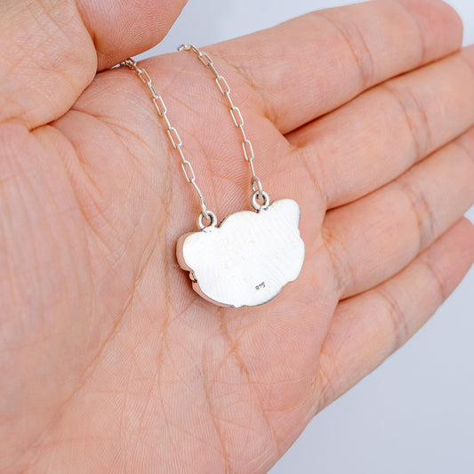 Sterling silver chain necklace with small heart-shaped pendant, clasp visible