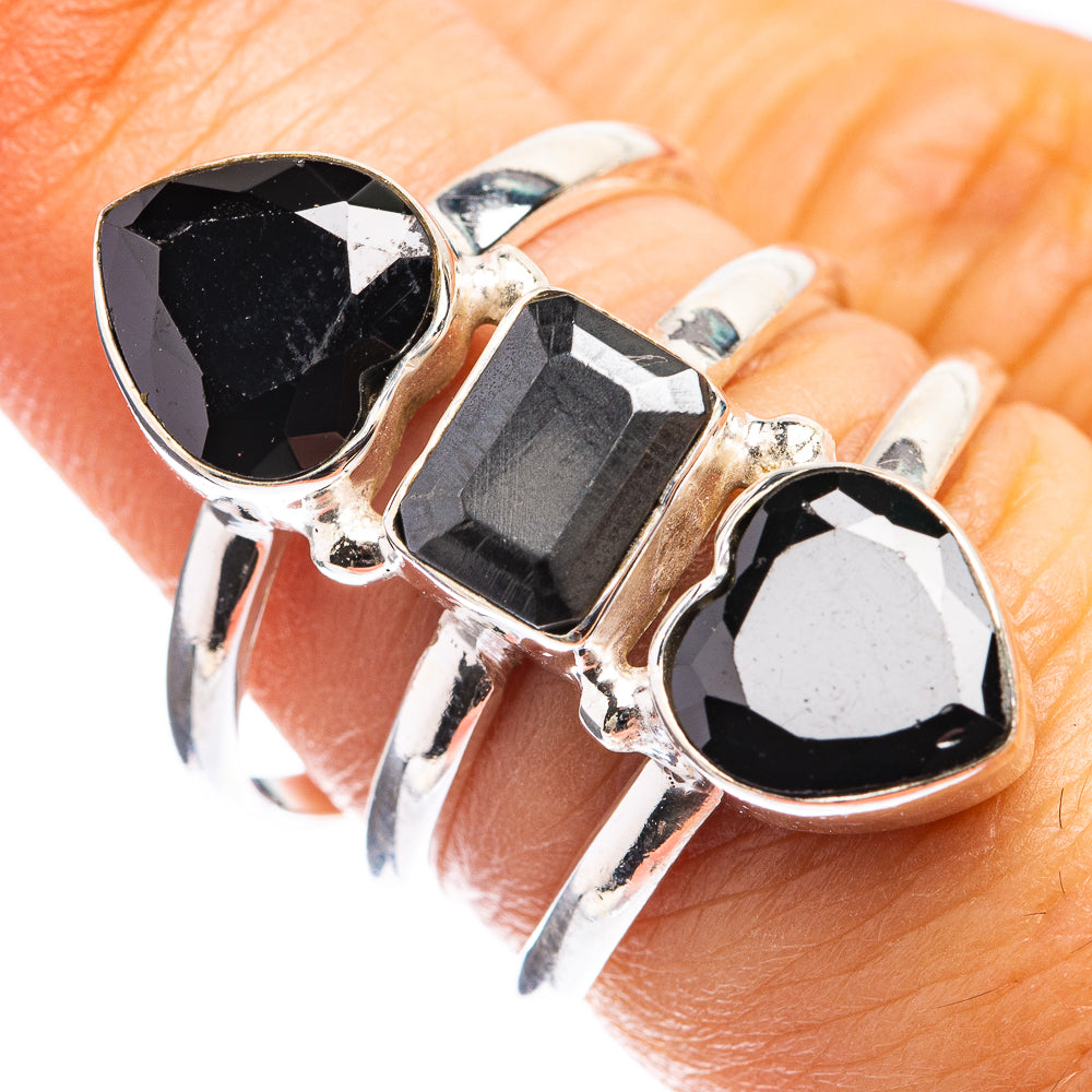 Sterling silver ring with three black faceted gemstones, side prong setting