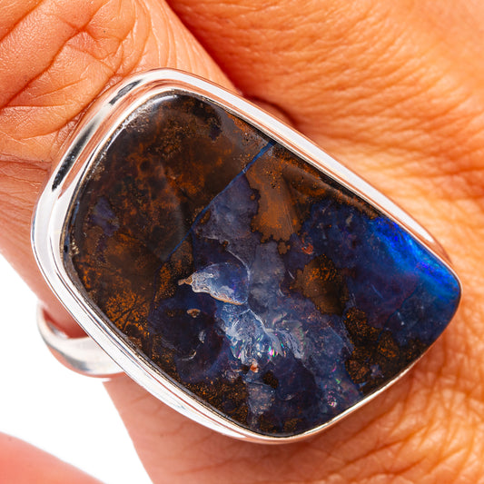 Sterling silver ring with blue-and-brown boulder opal cabochon on finger