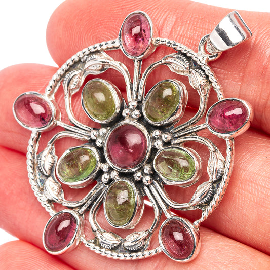 Sterling silver pendant with pink and green cabochon stones, ornate round setting