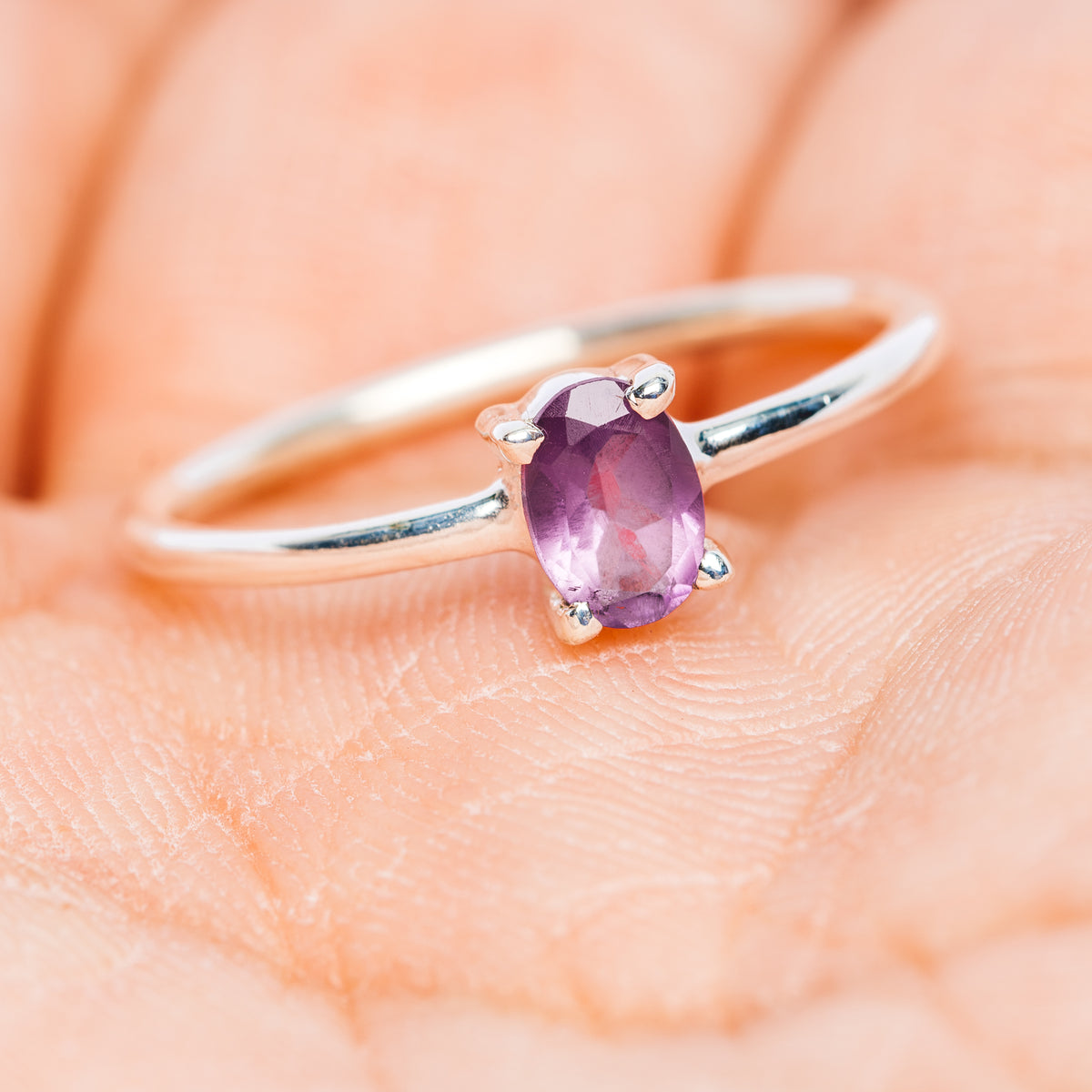 Stackable sterling silver ring with oval purple amethyst and black enamel side accents
