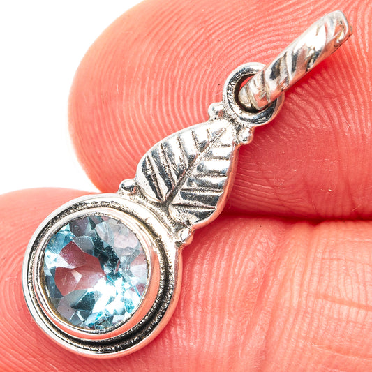 Sterling silver blue topaz pendant with round bezel and leaf-shaped bail