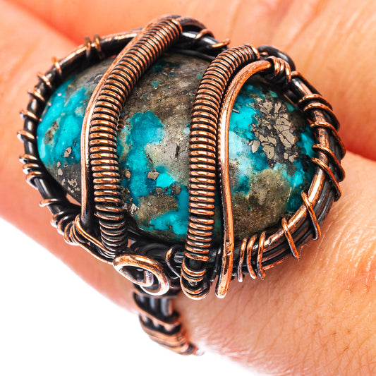 Turquoise wire-wrapped ring with oval stone, oxidized copper coil and dark base