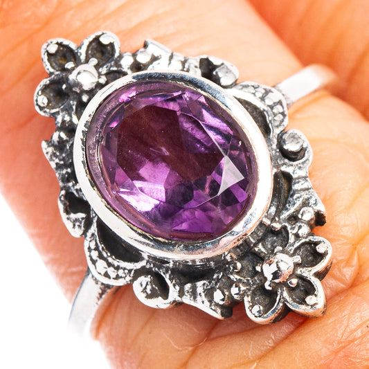 Sterling silver amethyst ring with oval purple gemstone and ornate floral halo
